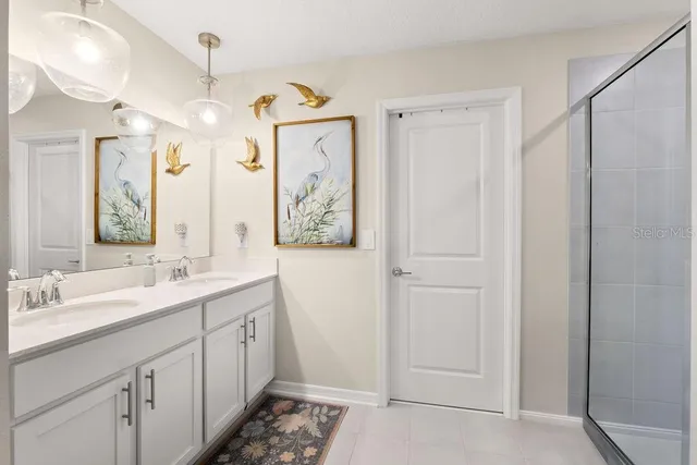 a spacious bathroom with a double vanity sink mirror and double