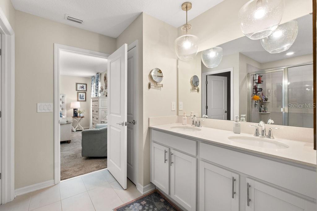 2821 Muller Oak Loop Ocoee, FL 34761 - Photo 26 of 45 a spacious bathroom with a shower sink and mirror