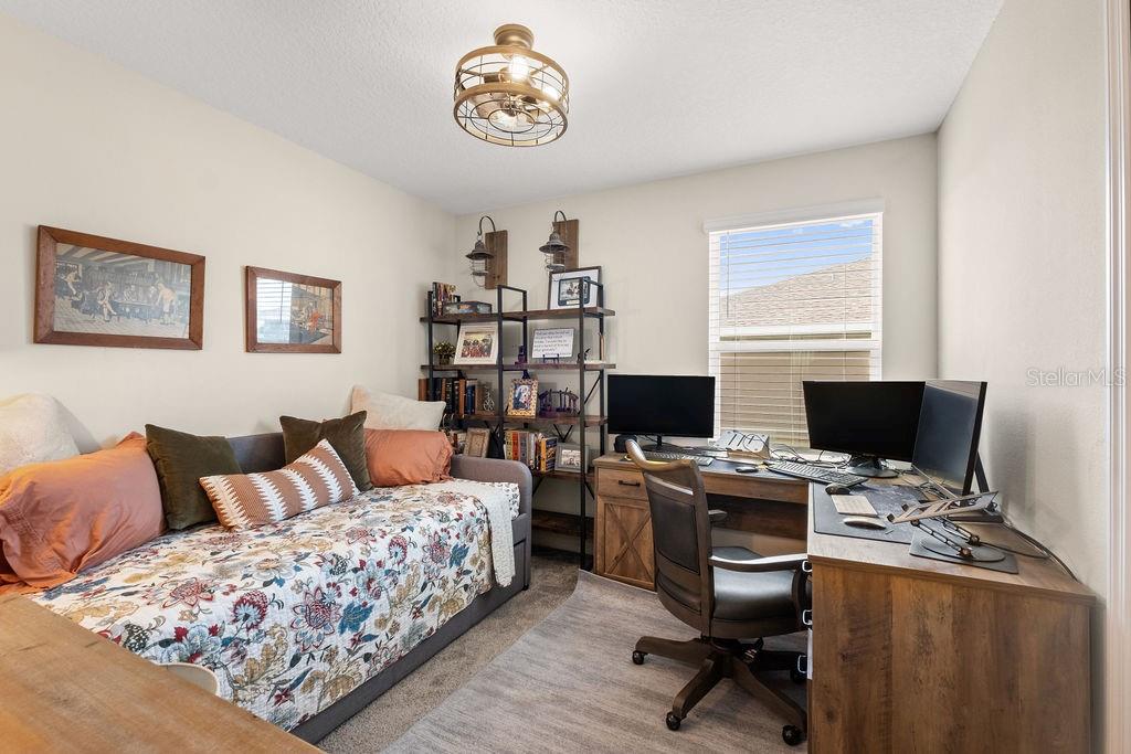 2821 Muller Oak Loop Ocoee, FL 34761 - Photo 27 of 45 a bedroom with a bed and a desk