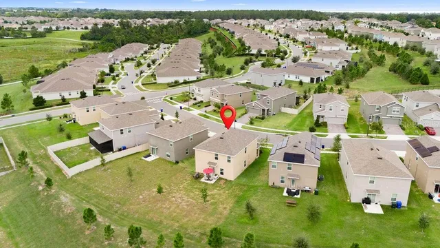 an aerial view of house with yard swimming pool and outdoor seating