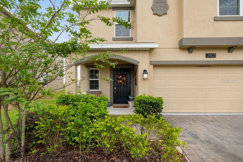 2821 Muller Oak Loop Ocoee, FL 34761 - Photo 4 of 45 a front view of a house with garden