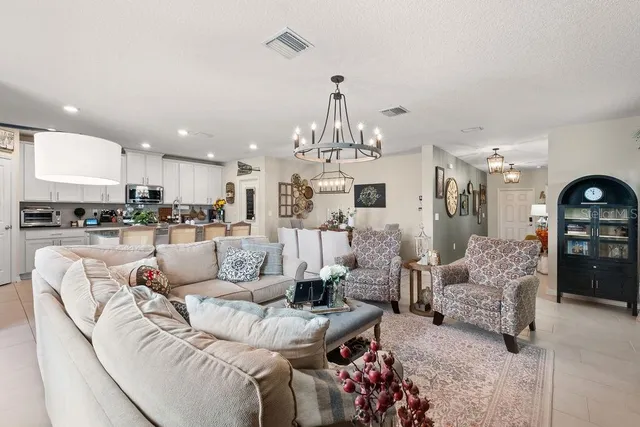 a living room with furniture and kitchen view