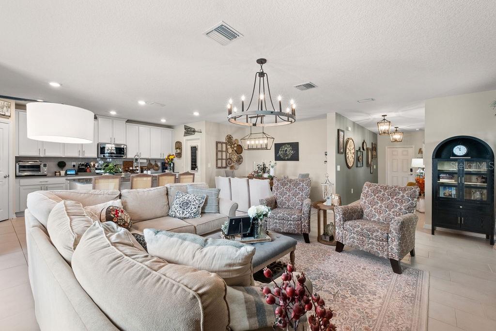 2821 Muller Oak Loop Ocoee, FL 34761 - Photo 9 of 45 a living room with furniture and kitchen view