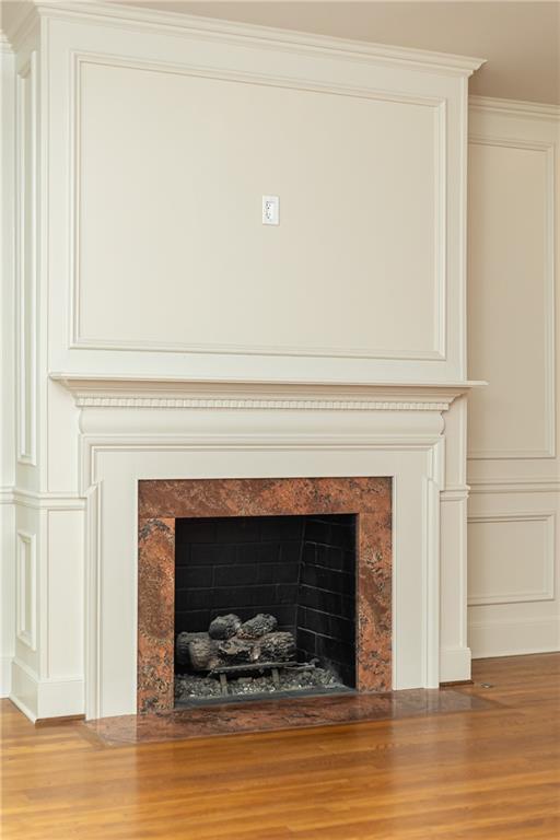 3384 Rilman Road Northwest Atlanta, GA 30327 - Photo 14 of 68 a living room with a fireplace and a wooden floor
