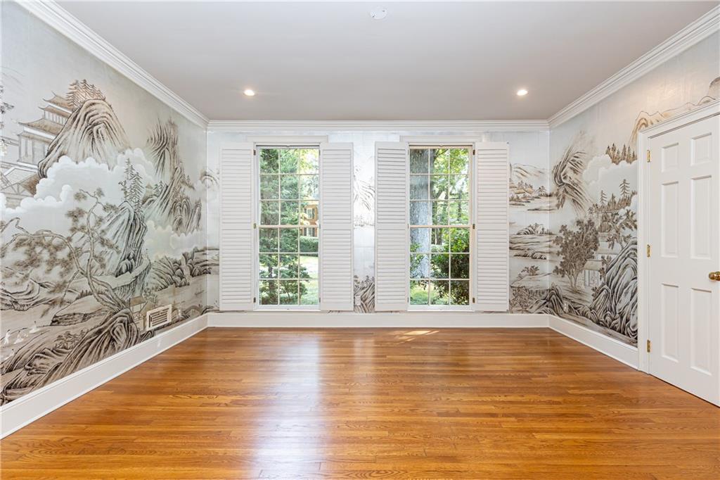 3384 Rilman Road Northwest Atlanta, GA 30327 - Photo 17 of 68 a view of an empty room with a window and wooden floor