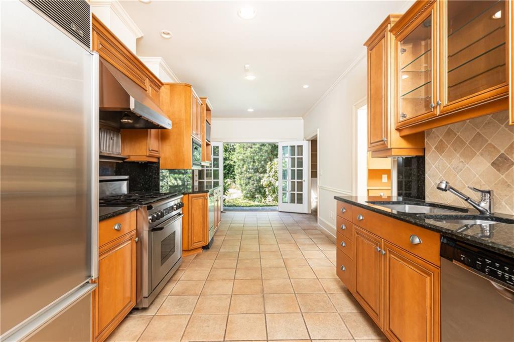 3384 Rilman Road Northwest Atlanta, GA 30327 - Photo 20 of 68 a kitchen with stainless steel appliances granite countertop a stove a sink and a microwave