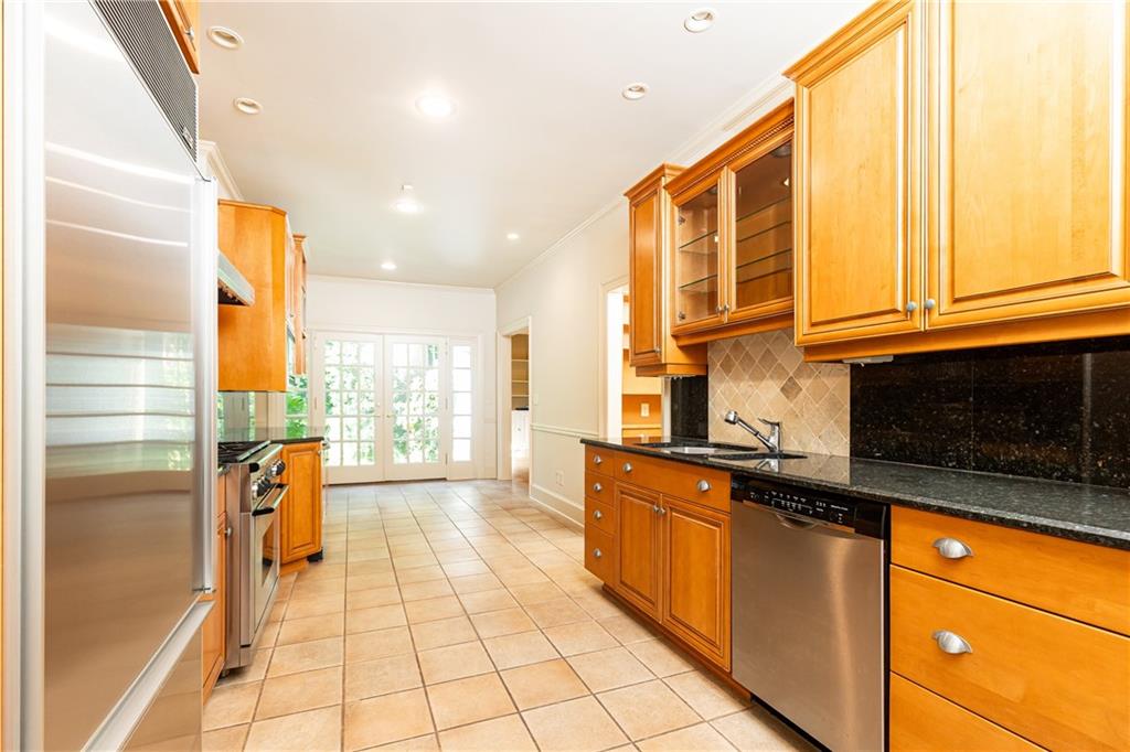 3384 Rilman Road Northwest Atlanta, GA 30327 - Photo 21 of 68 a kitchen with stainless steel appliances granite countertop a stove a sink and a microwave