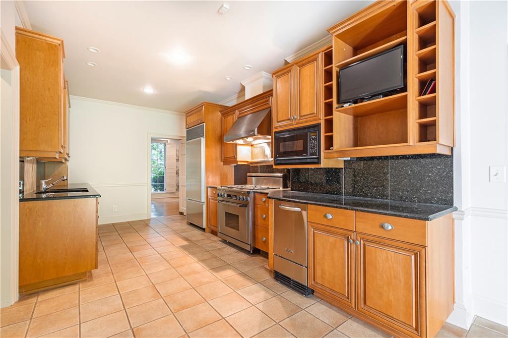 3384 Rilman Road Northwest Atlanta, GA 30327 - Photo 23 of 68 a kitchen with stainless steel appliances granite countertop a stove and a refrigerator