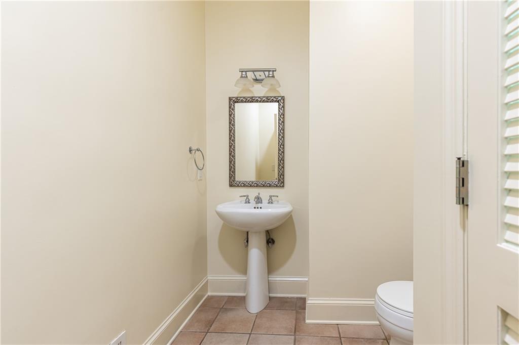 3384 Rilman Road Northwest Atlanta, GA 30327 - Photo 28 of 68 a bathroom with a sink a toilet and mirror