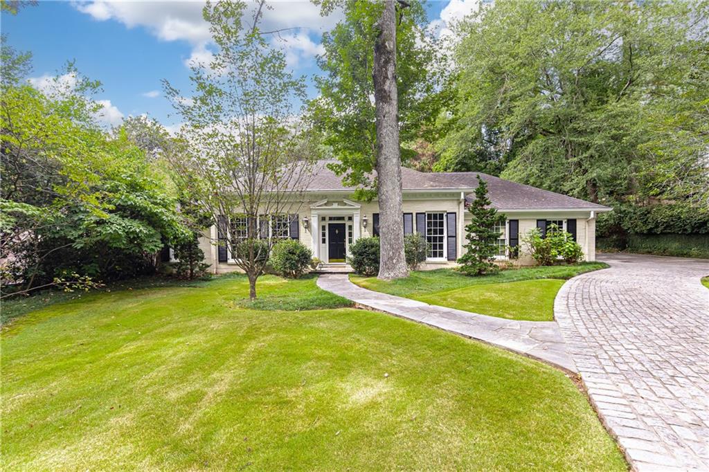 3384 Rilman Road Northwest Atlanta, GA 30327 - Photo 3 of 68 a view of house with a big yard and large trees
