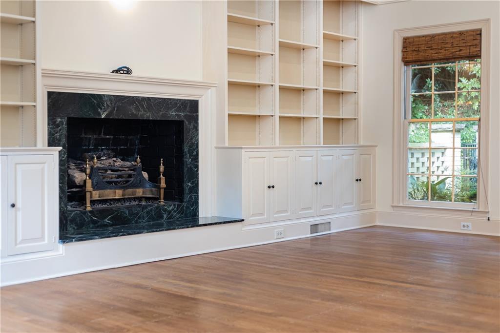 3384 Rilman Road Northwest Atlanta, GA 30327 - Photo 31 of 68 a living room with a fireplace and a floor to ceiling window