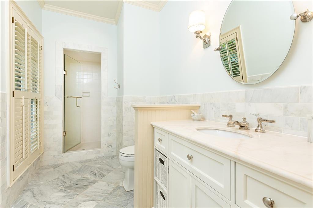 3384 Rilman Road Northwest Atlanta, GA 30327 - Photo 35 of 68 a bathroom with a sink a toilet and a mirror