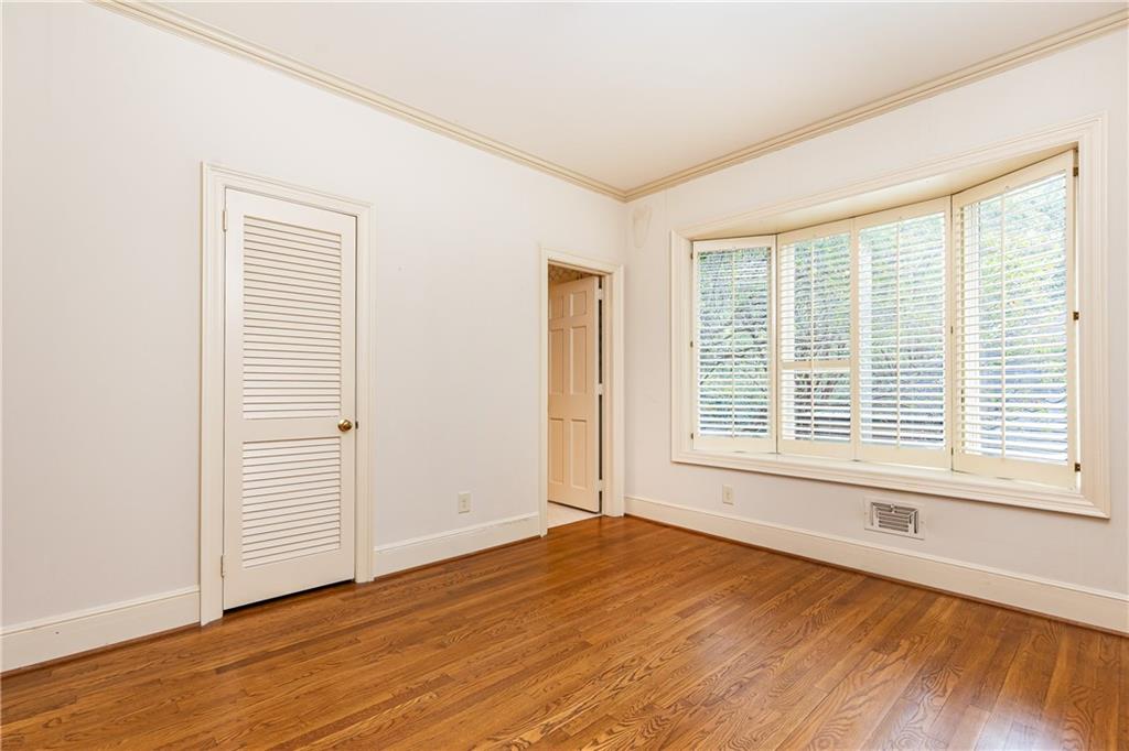 3384 Rilman Road Northwest Atlanta, GA 30327 - Photo 36 of 68 a view of an empty room with wooden floor and a window