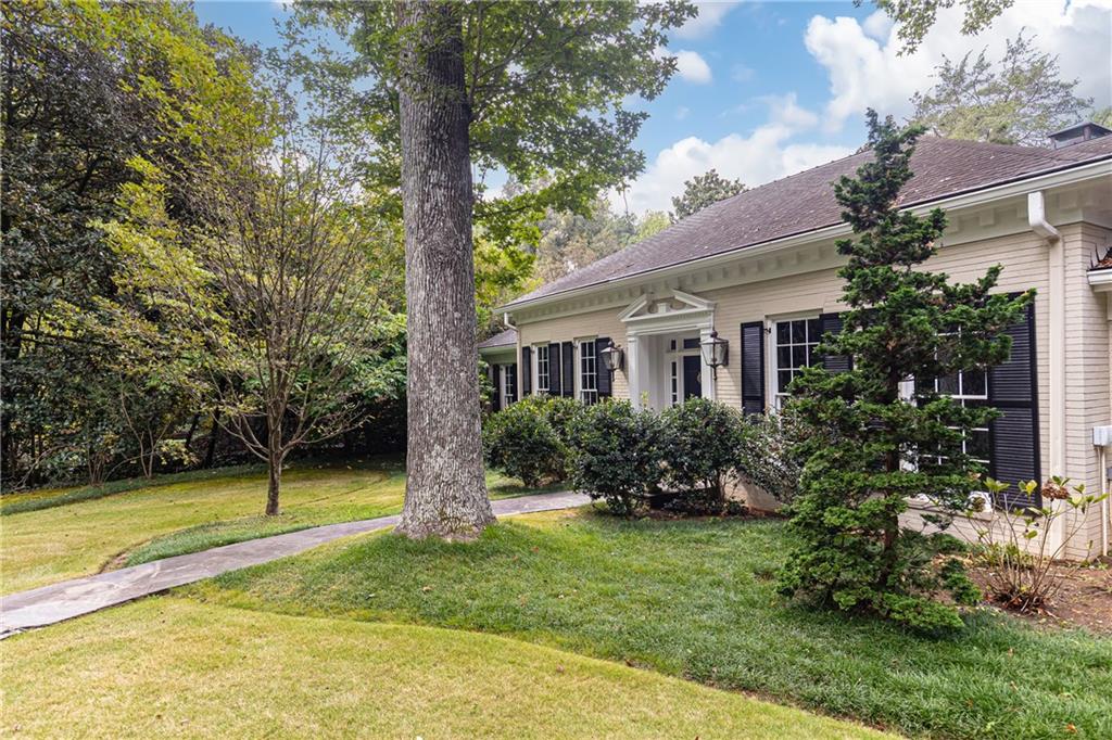3384 Rilman Road Northwest Atlanta, GA 30327 - Photo 4 of 68 a front view of a house with a yard