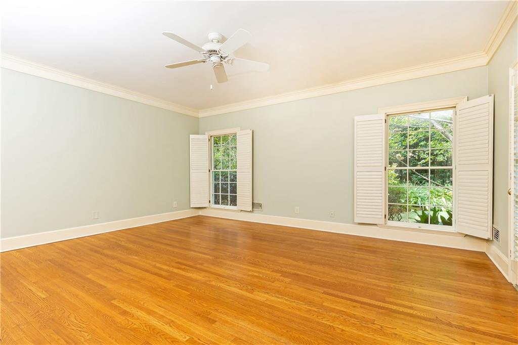 3384 Rilman Road Northwest Atlanta, GA 30327 - Photo 41 of 68 an empty room with wooden floor fan and windows