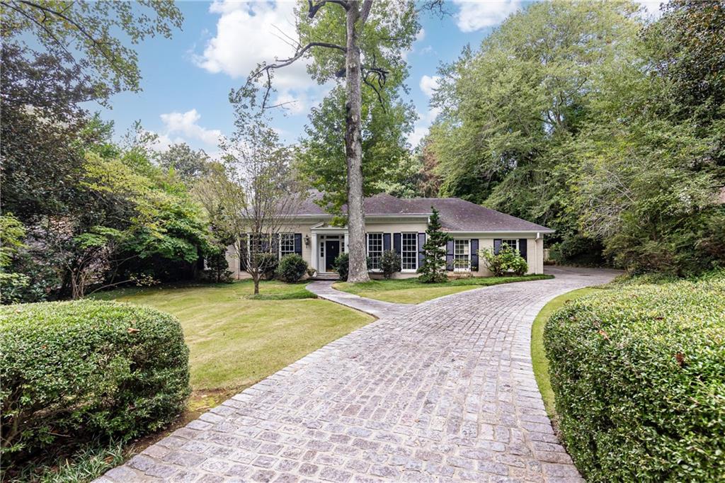 3384 Rilman Road Northwest Atlanta, GA 30327 - Photo 5 of 68 a front view of a house with swimming pool having outdoor seating
