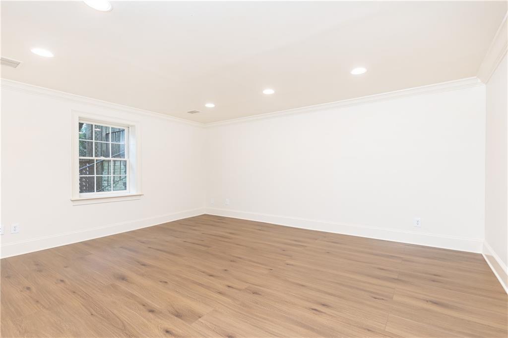 3384 Rilman Road Northwest Atlanta, GA 30327 - Photo 51 of 68 an empty room with wooden floor and windows