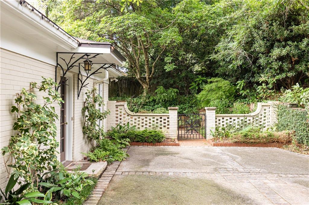 3384 Rilman Road Northwest Atlanta, GA 30327 - Photo 60 of 68 a front view of a house with a garden