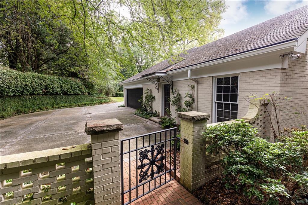 3384 Rilman Road Northwest Atlanta, GA 30327 - Photo 64 of 68 a view of a patio with table and chairs with wooden fence and plants