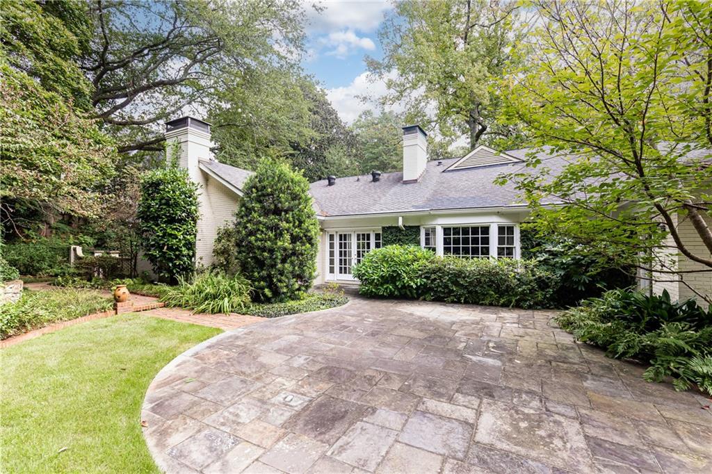 3384 Rilman Road Northwest Atlanta, GA 30327 - Photo 65 of 68 a front view of a house with a yard and trees