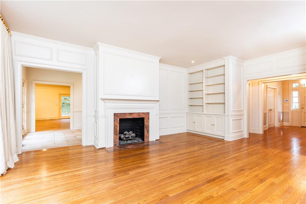 3384 Rilman Road Northwest Atlanta, GA 30327 - Photo 10 of 68 a view of empty room with wooden floor and fireplace