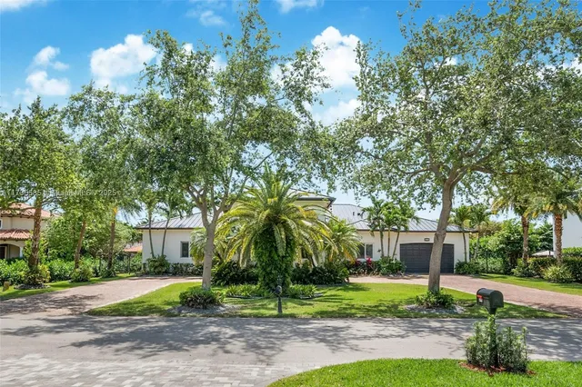 a view of a house with a yard and tree s