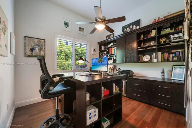 a view of a workspace with furniture and a window