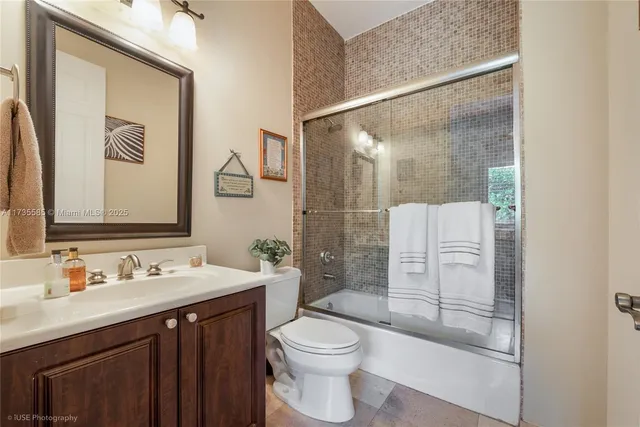 a bathroom with a sink vanity mirror and toilet
