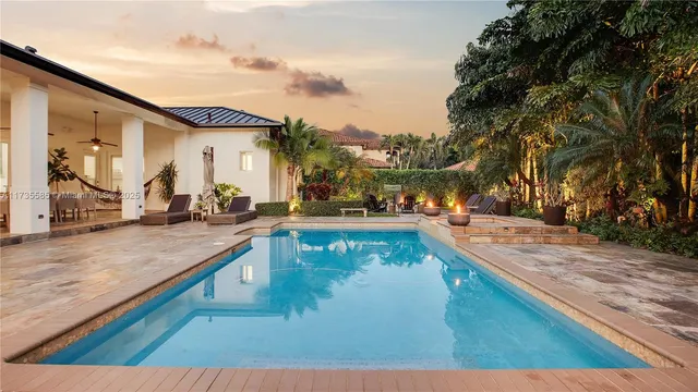 a view of a swimming pool with an outdoor seating