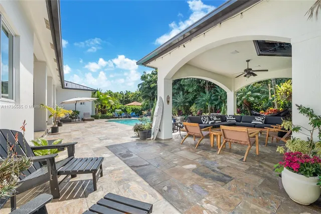 a view of a patio with chairs and potted plants
