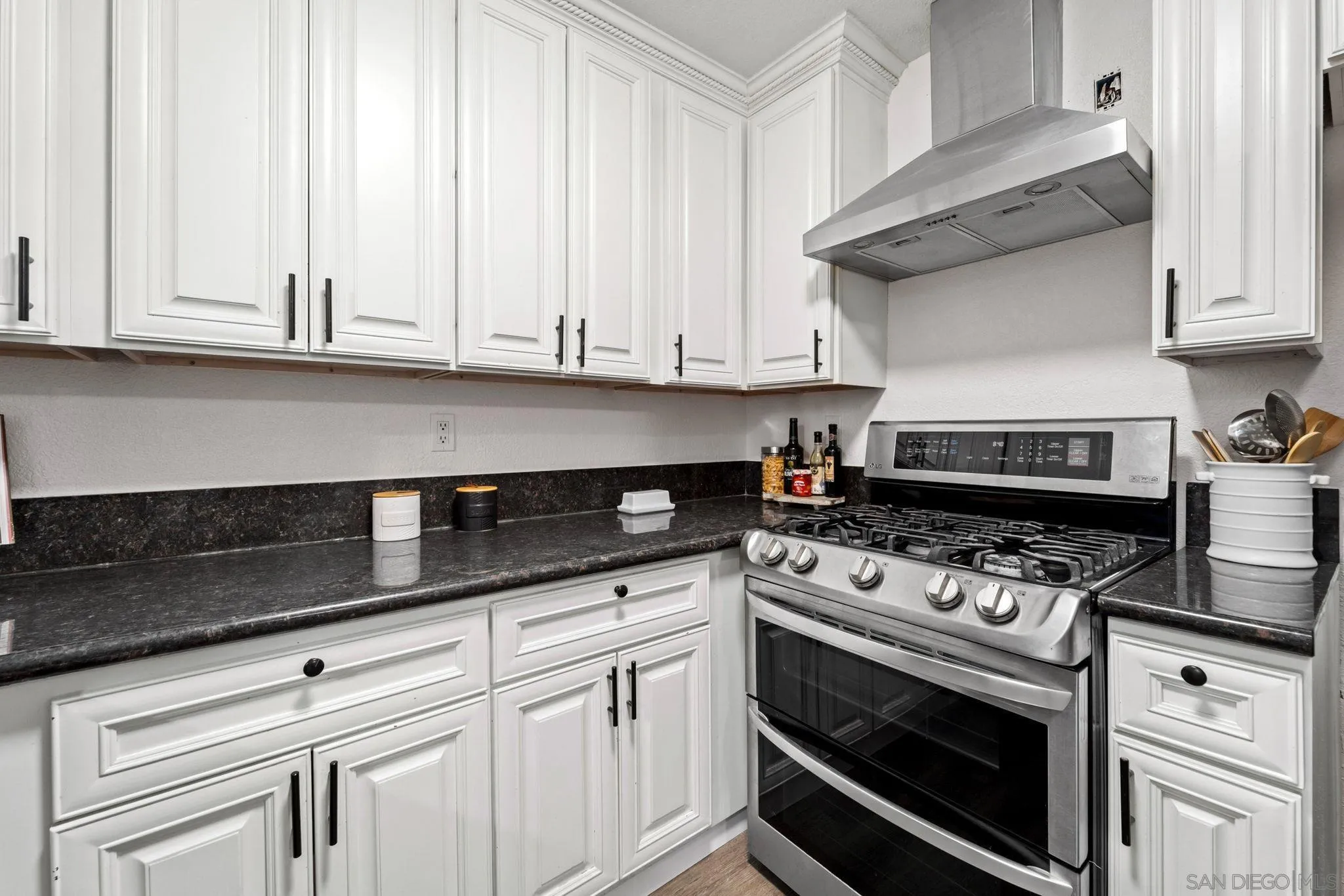564 Broadview Street Spring Valley, CA 91977 - Photo 11 of 53 a kitchen with granite countertop white cabinets and appliances
