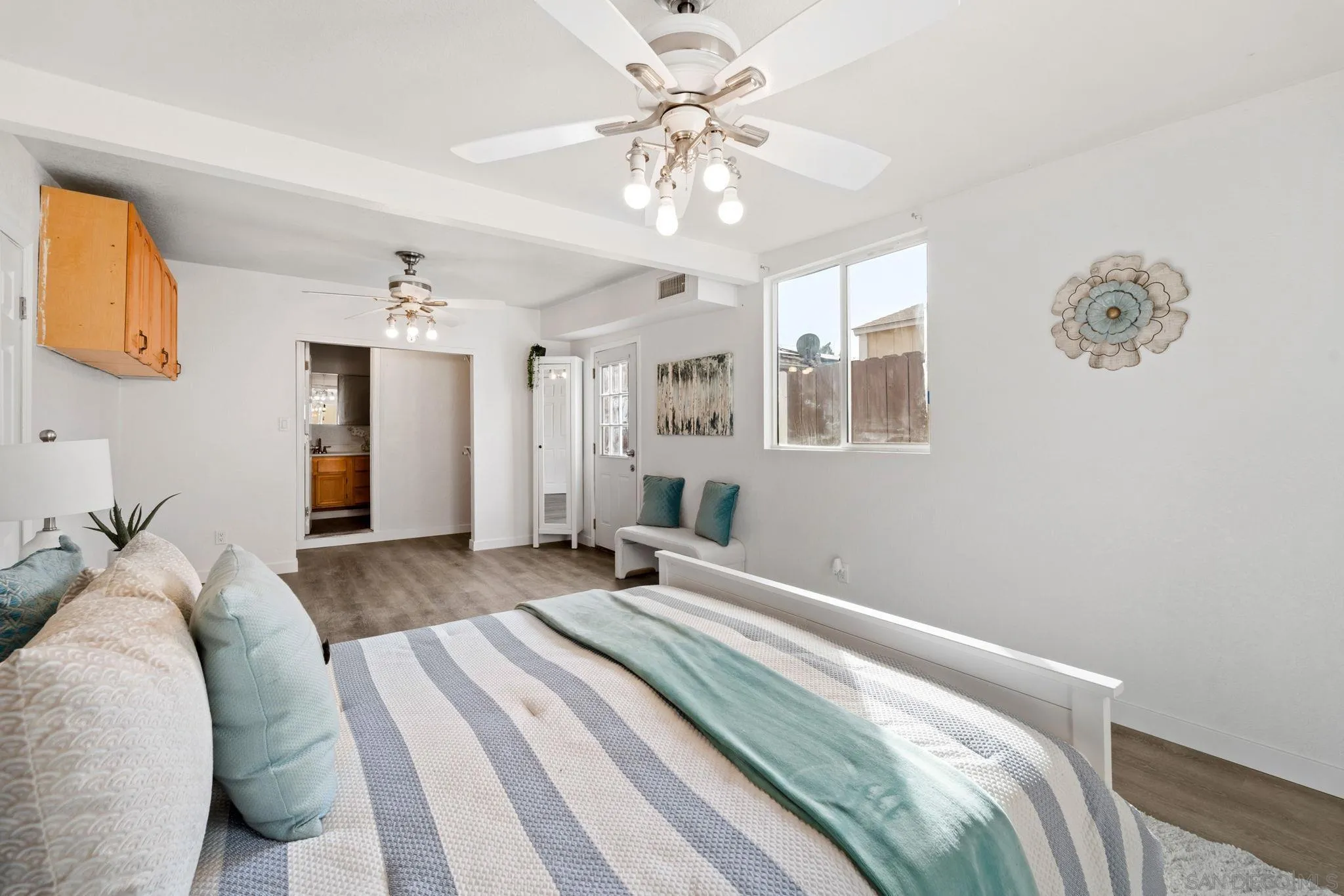 564 Broadview Street Spring Valley, CA 91977 - Photo 20 of 53 a bedroom with a large bed and a chandelier