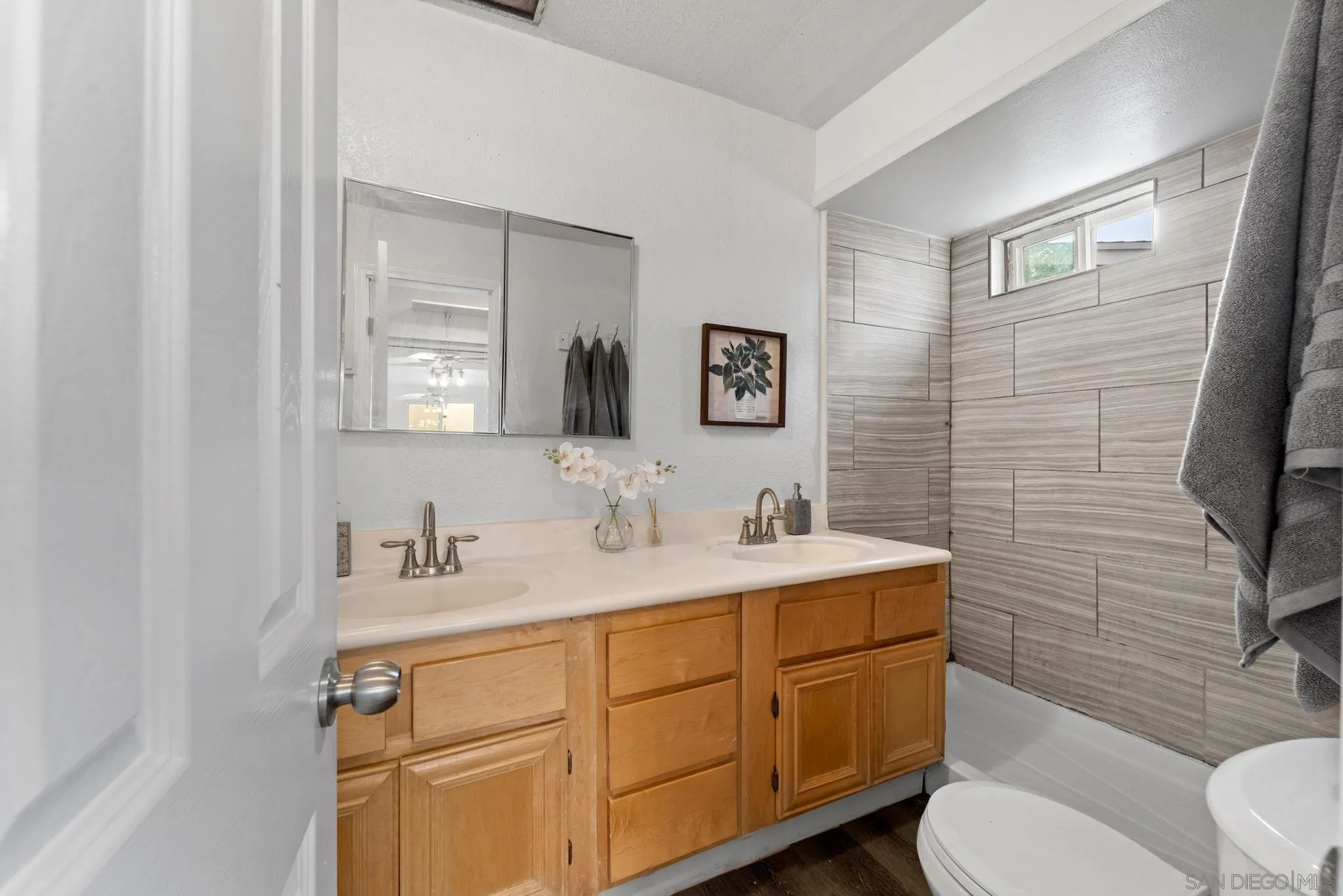 564 Broadview Street Spring Valley, CA 91977 - Photo 23 of 53 a bathroom with a toilet sink and mirror