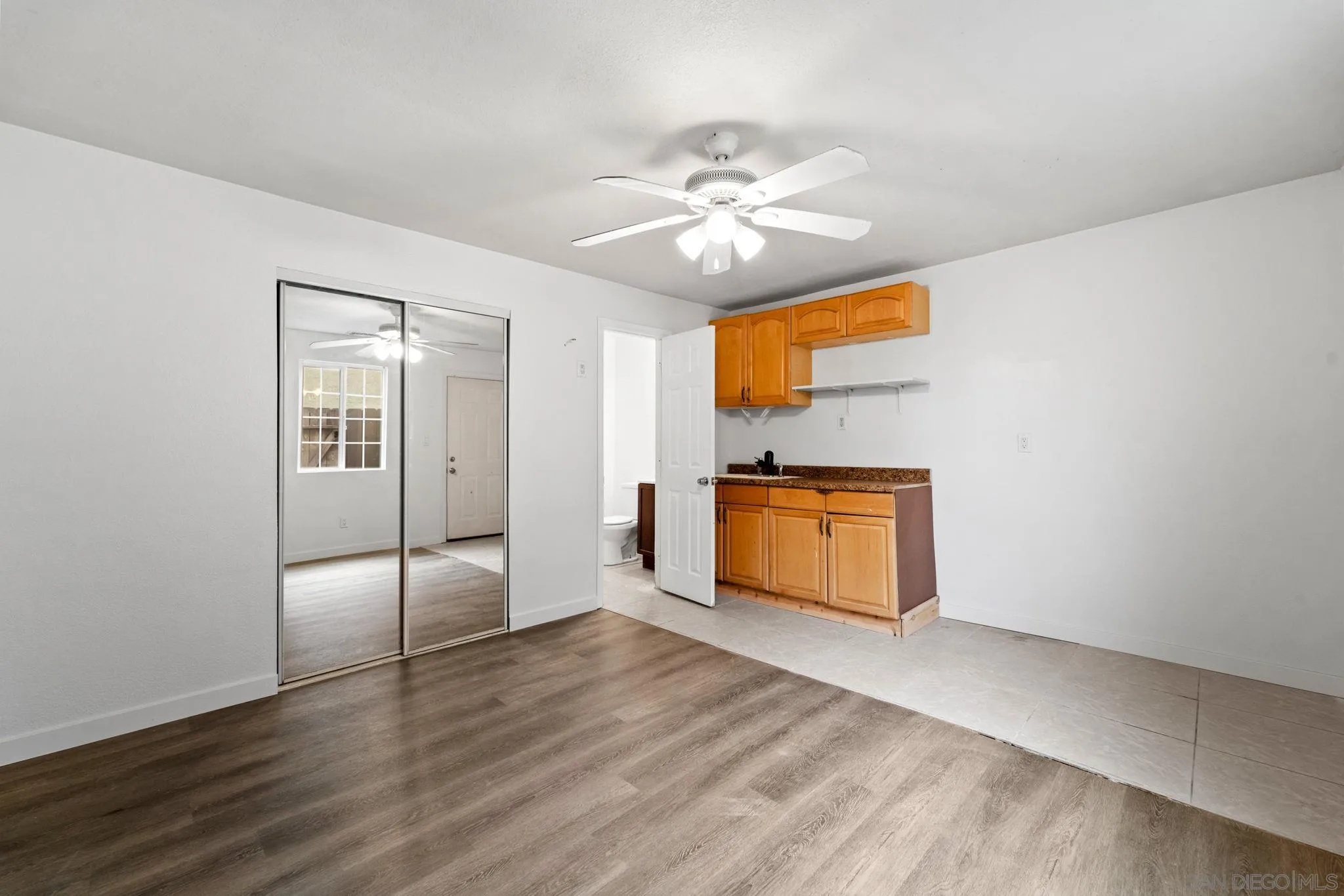 564 Broadview Street Spring Valley, CA 91977 - Photo 33 of 53 a view of a kitchen with wooden floor fridge and a sink
