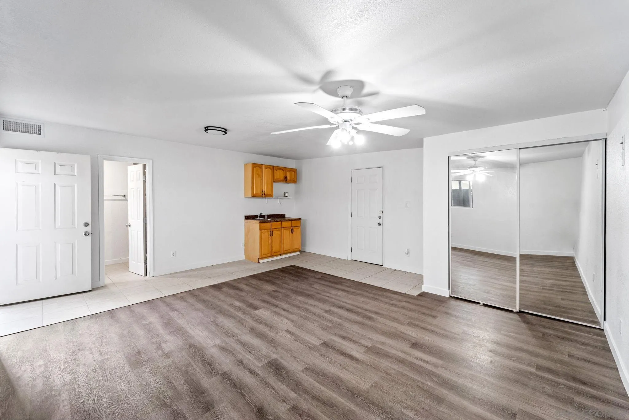 564 Broadview Street Spring Valley, CA 91977 - Photo 37 of 53 an empty room with wooden floor and a ceiling fan