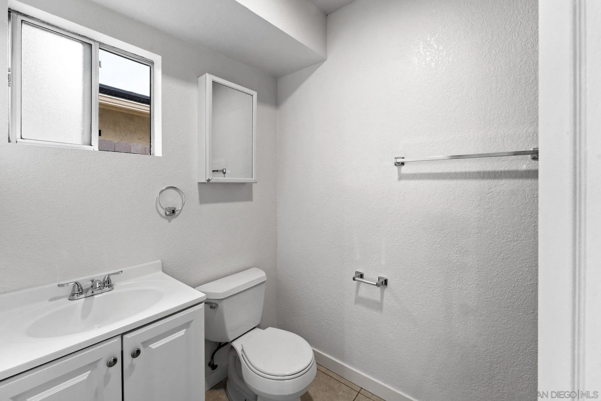 564 Broadview Street Spring Valley, CA 91977 - Photo 39 of 53 a bathroom with a sink mirror vanity and toilet