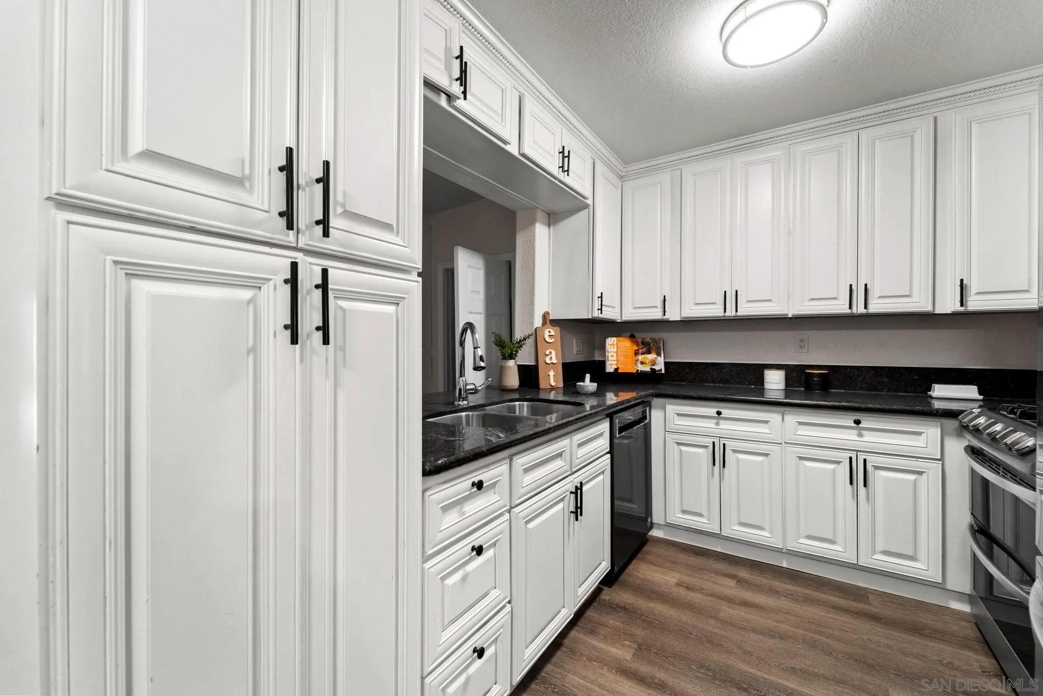 564 Broadview Street Spring Valley, CA 91977 - Photo 9 of 53 a kitchen with stainless steel appliances granite countertop a stove a sink and white cabinets