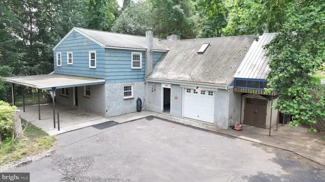 front view of a house with a barbeque and table and chairs