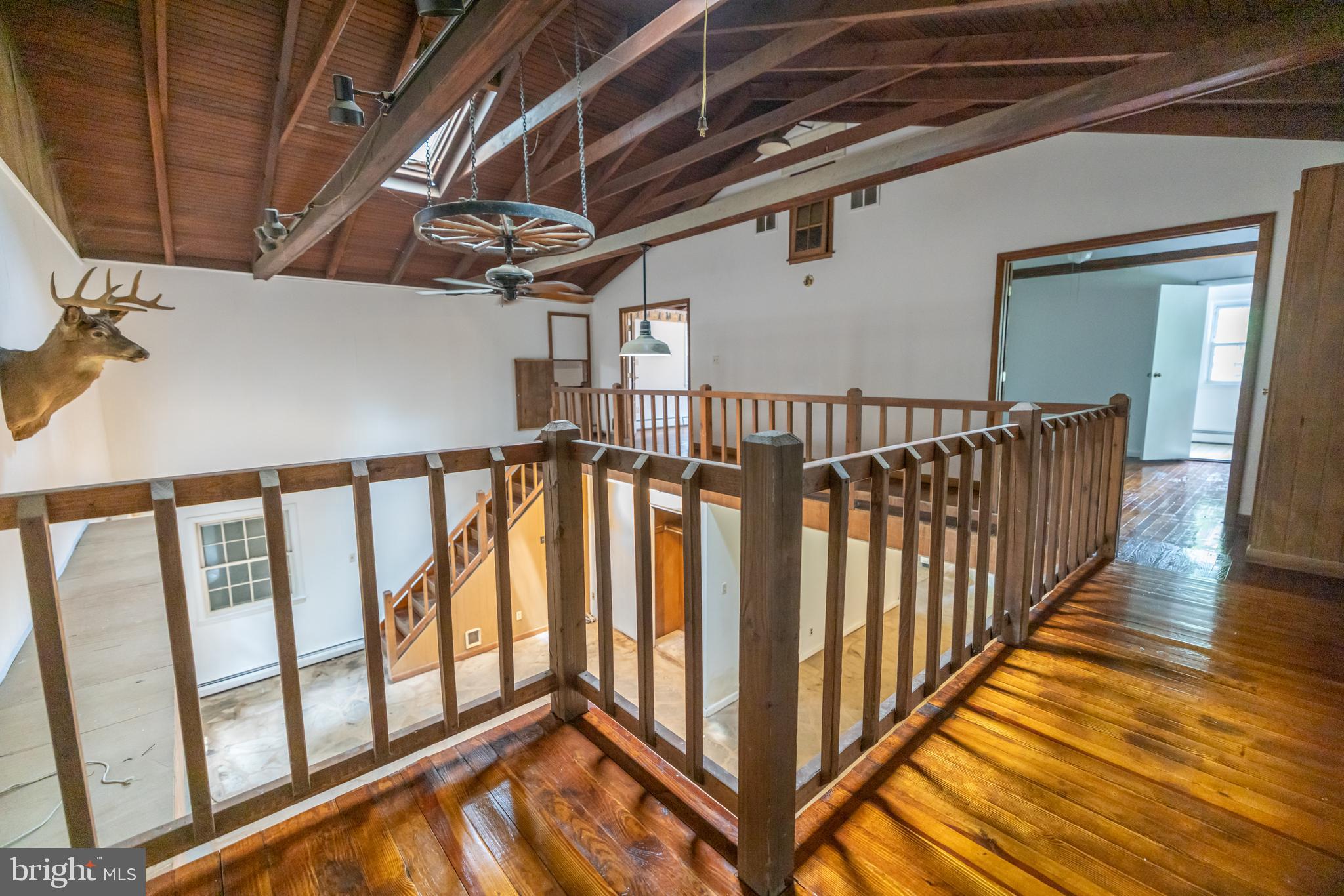 160 Stoney Bank Road Glen Mills, PA 19342 - Photo 16 of 46 a view of staircase with lots of frames on wall and wooden floor