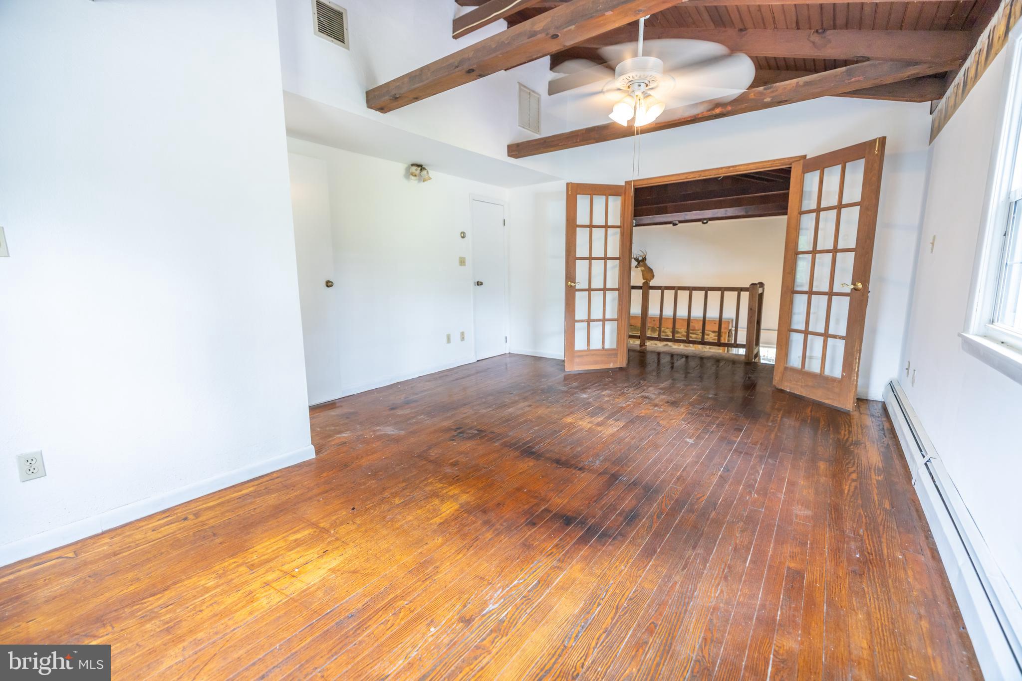 160 Stoney Bank Road Glen Mills, PA 19342 - Photo 20 of 46 a view of an empty room with wooden floor and a window