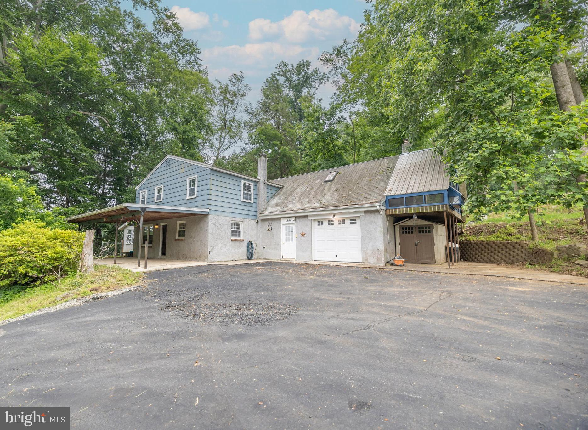 160 Stoney Bank Road Glen Mills, PA 19342 - Photo 2 of 46 a front view of a house with a garden
