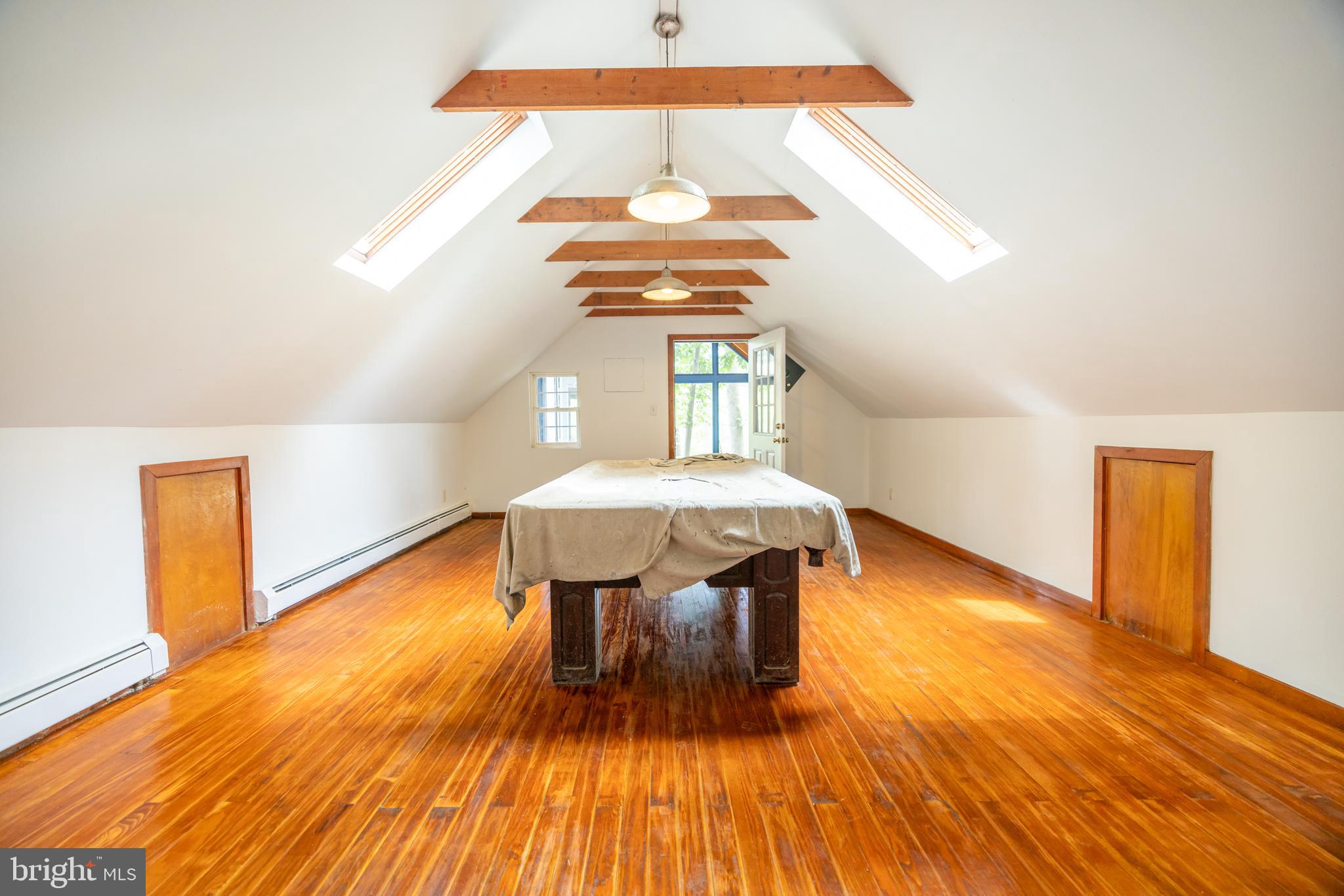 160 Stoney Bank Road Glen Mills, PA 19342 - Photo 24 of 46 a view of a room with wooden floor a sink a book and table