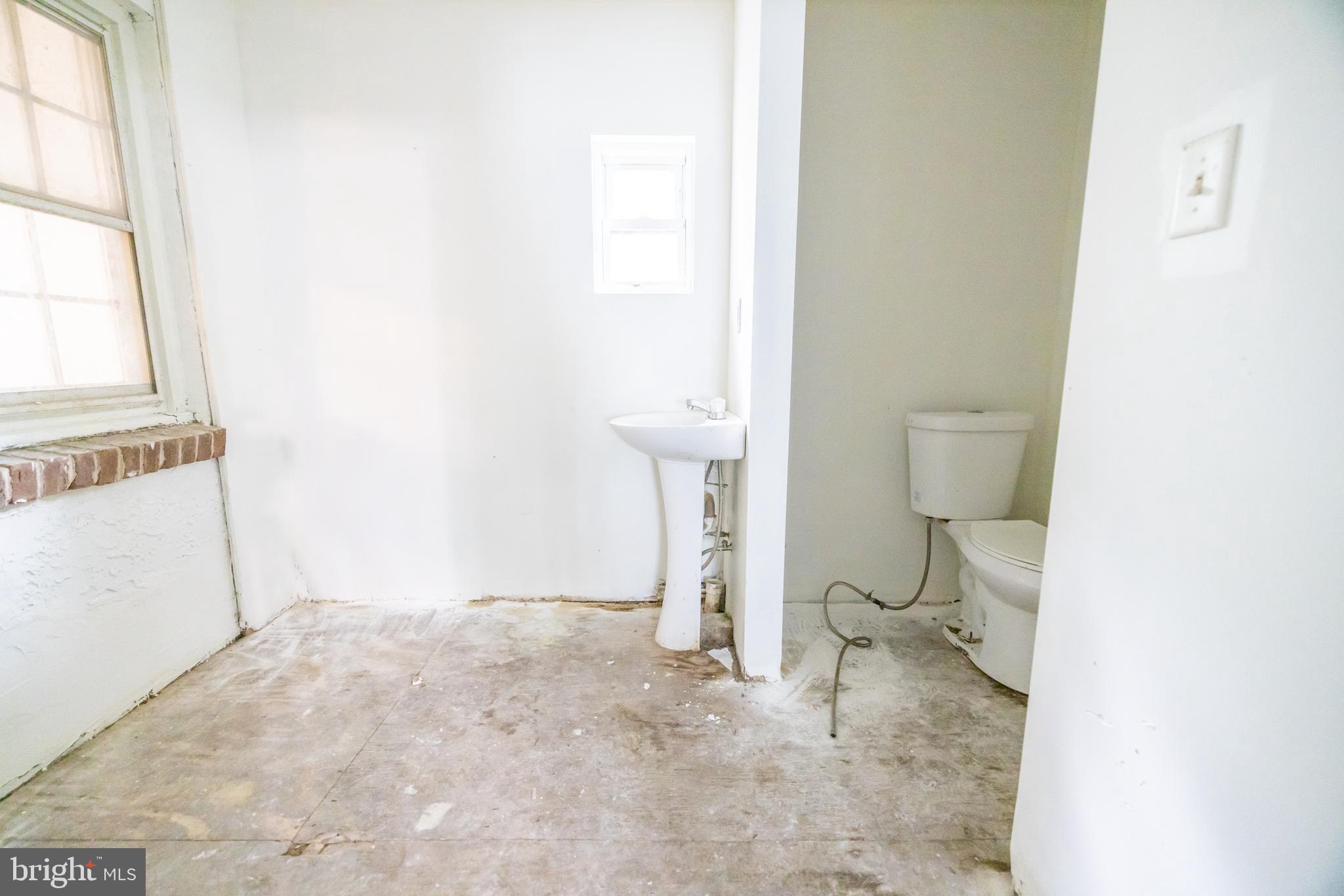 160 Stoney Bank Road Glen Mills, PA 19342 - Photo 30 of 46 a white toilet sitting next to a bathroom sink