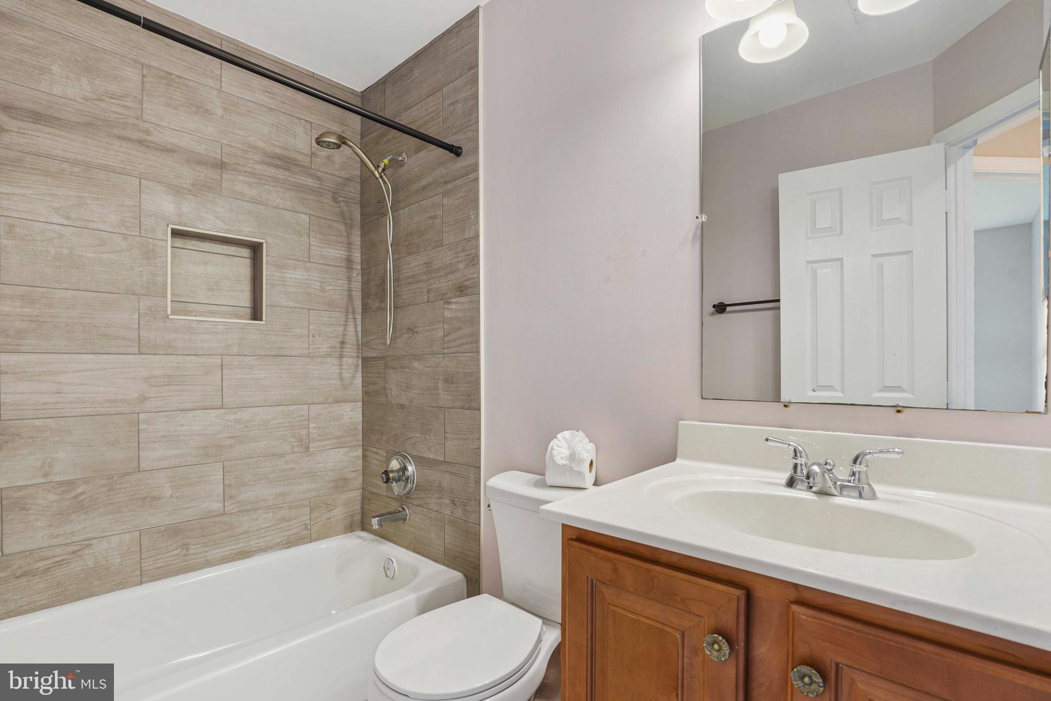 20783 Apollo Terrace Ashburn, VA 20147 - Photo 22 of 33 a bathroom with a granite countertop sink toilet and shower