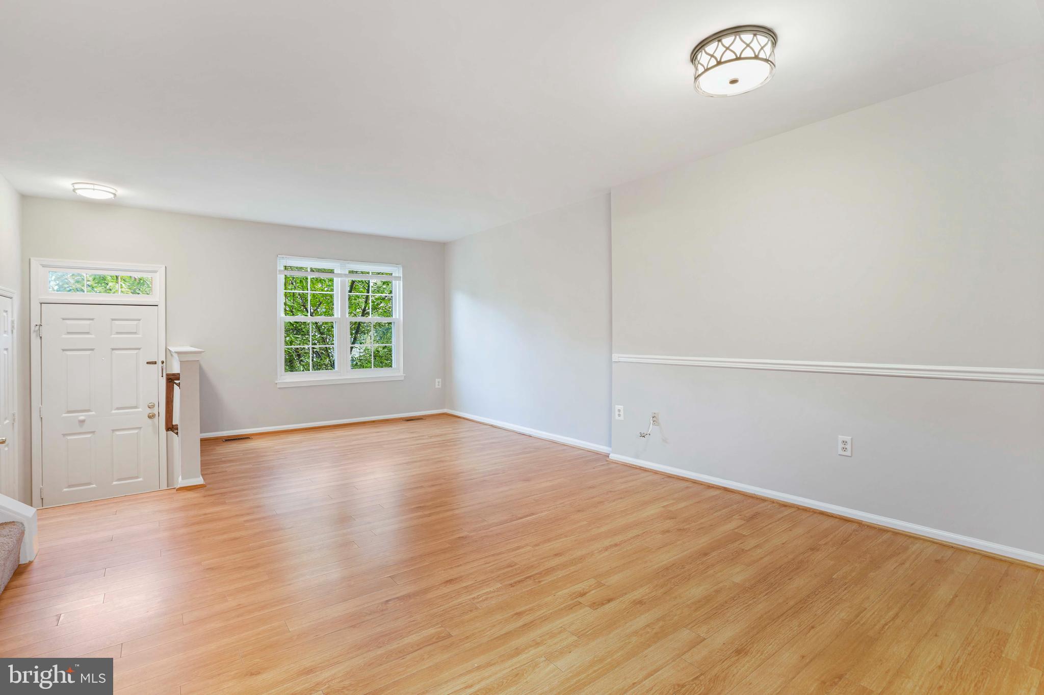 20783 Apollo Terrace Ashburn, VA 20147 - Photo 7 of 33 an empty room with wooden floor and windows