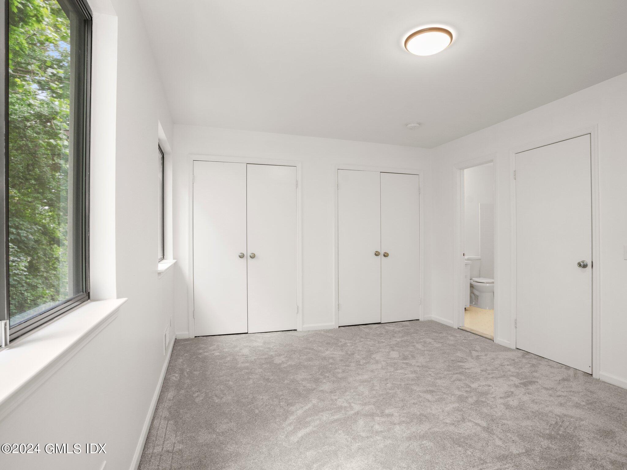 413 Glenbrook Road, Unit 1 Stamford, CT 06906 - Photo 12 of 21 an empty room with a natural light