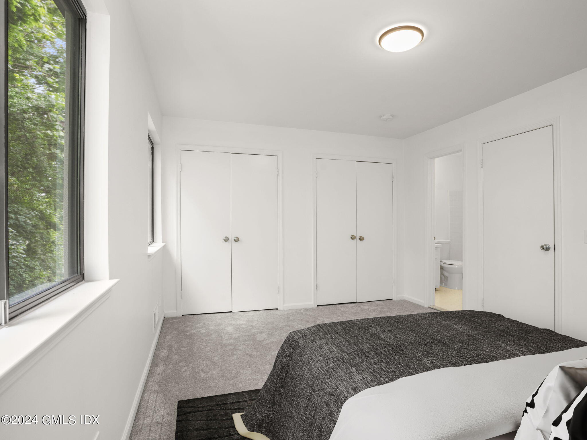 413 Glenbrook Road, Unit 1 Stamford, CT 06906 - Photo 13 of 21 a spacious bedroom with a bed and a window