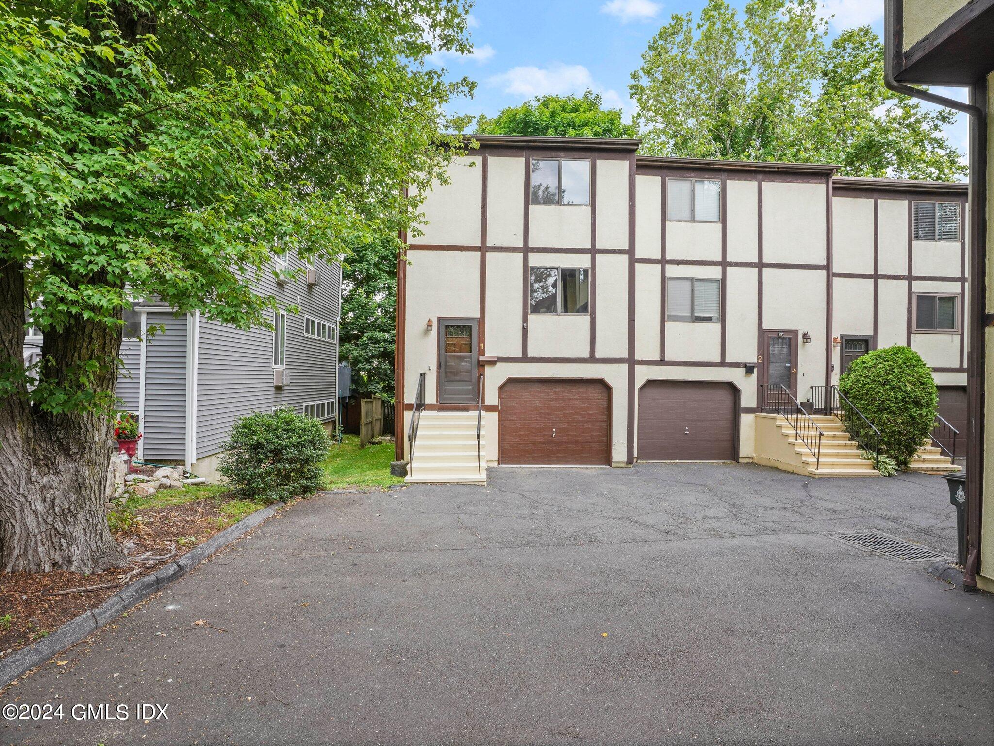 413 Glenbrook Road, Unit 1 Stamford, CT 06906 - Photo 2 of 21 a view of a house with backyard and garden