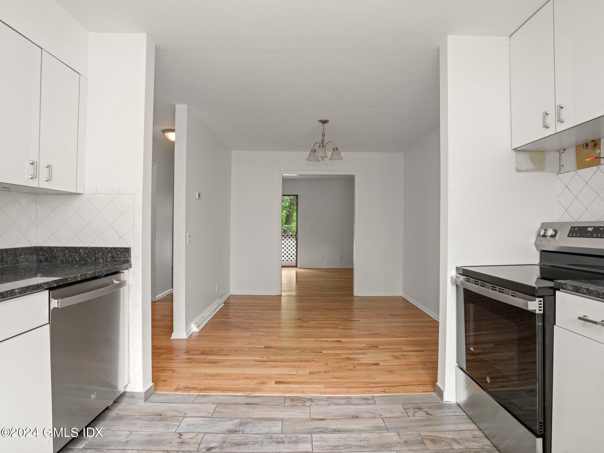 413 Glenbrook Road, Unit 1 Stamford, CT 06906 - Photo 4 of 21 a view of kitchen with wooden floor electronic appliances and cabinets