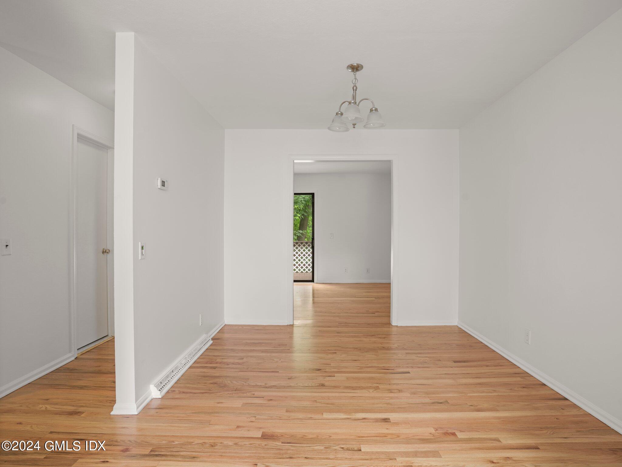 413 Glenbrook Road, Unit 1 Stamford, CT 06906 - Photo 5 of 21 a view of an empty room with wooden floor and closet